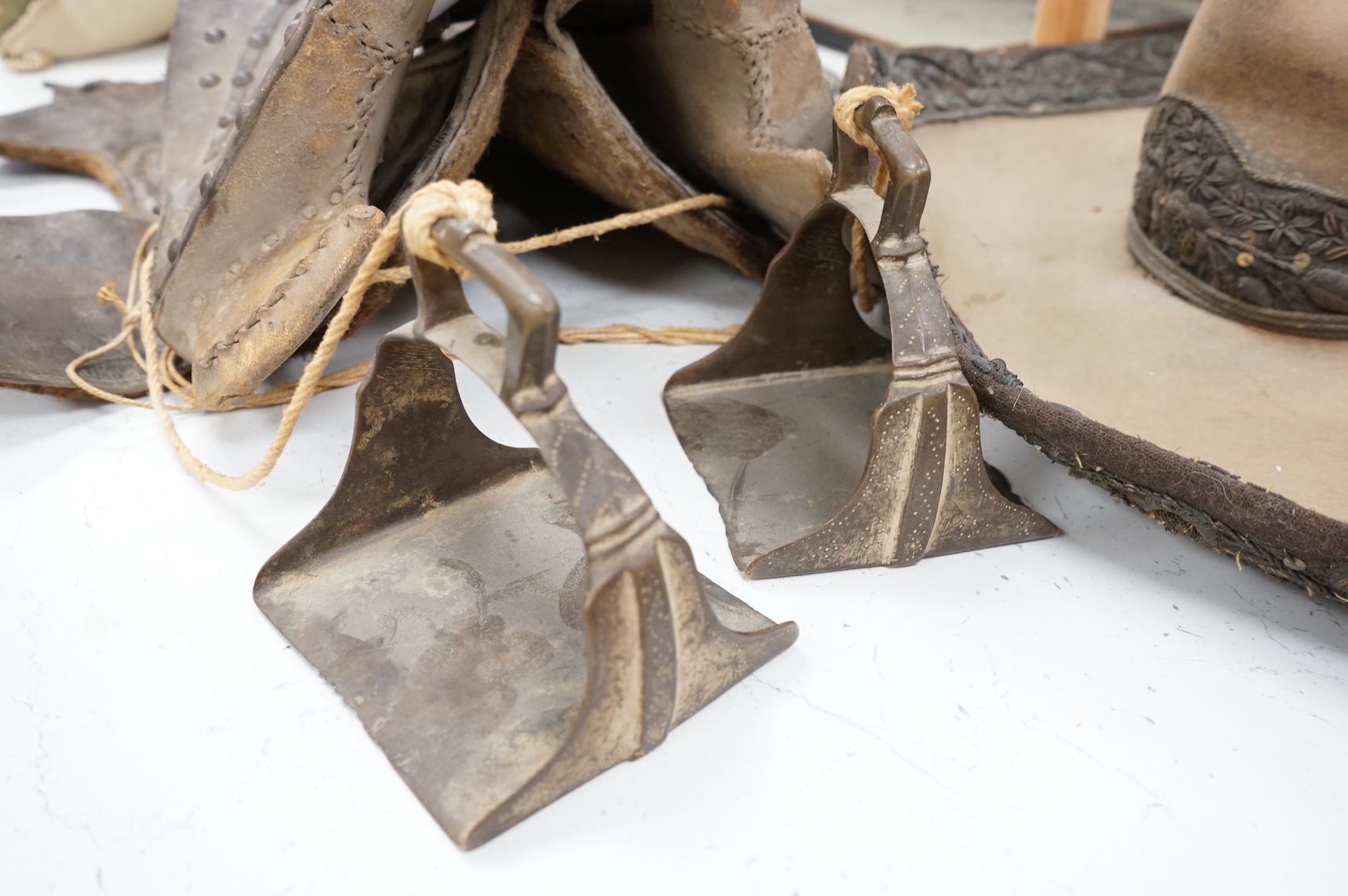 A Spanish Colonial leather saddle and a Spanish Colonial bullion work sombrero, saddle 59cm long